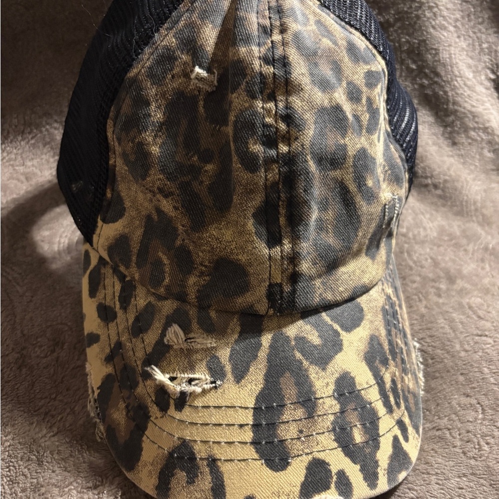 Criss Cross Leopard Print  ponytail Hat with Distressed areas .